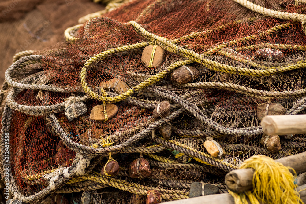 Old fishing net with floats, laid on the ship close-up Stock Photo