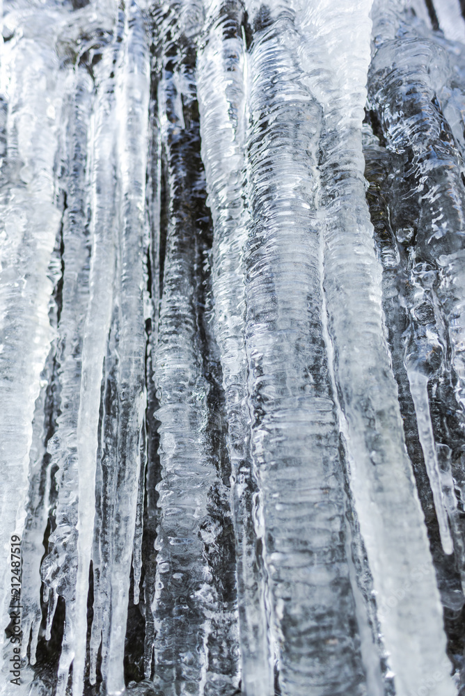 Icicles on the rocks inside of the forest