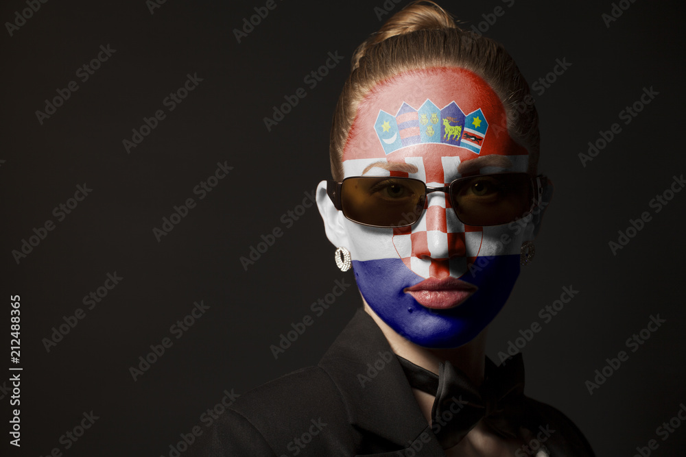 Portrait of woman with painted Croatia Flag and sunglasses Portrait of woman with painted Croatia Flag and sunglasses