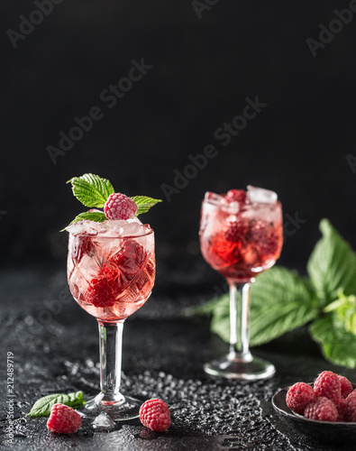 Fresh raspberry cocktail. Fresh summer cocktail with raspberry and ice cubes. Glass of raspberry mojito