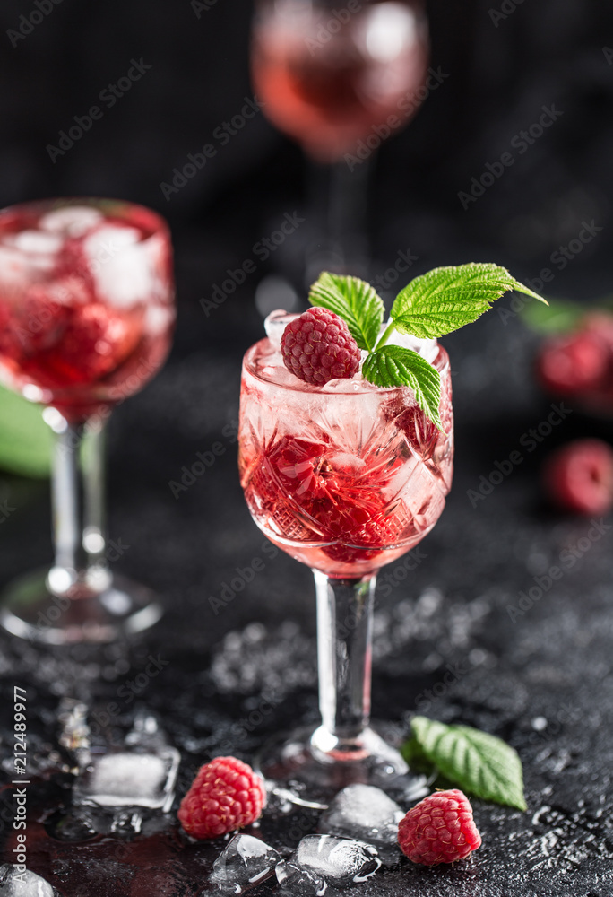 Fresh raspberry cocktail. Fresh summer cocktail with raspberry and ice cubes. Glass of raspberry mojito Fresh raspberry cocktail. Fresh summer cocktail with raspberry and ice cubes. Glass of raspberry mojito
