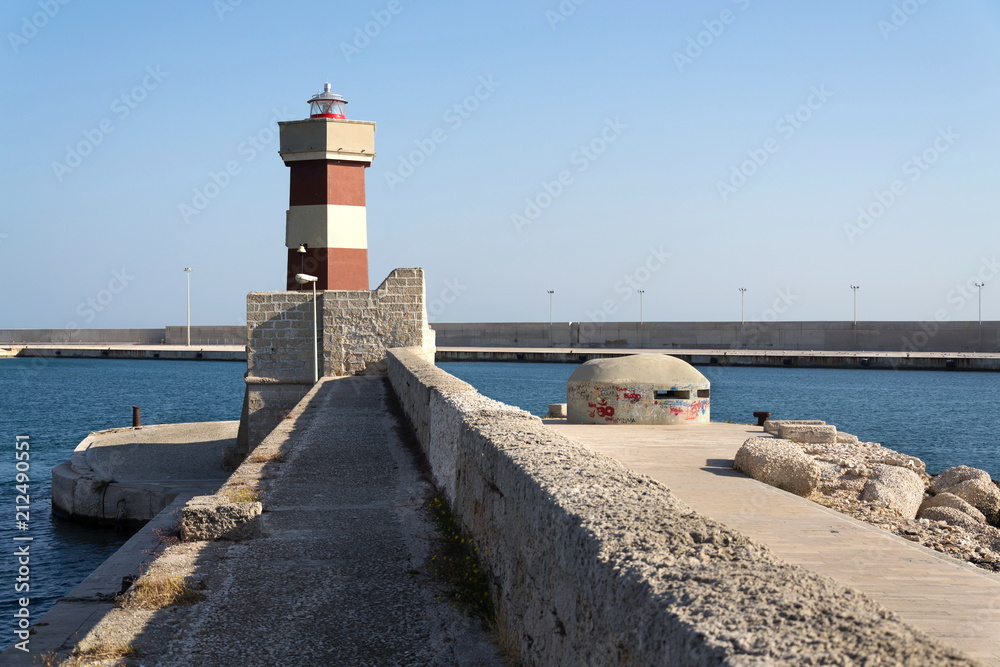 Lighthouse in Monopoli port in front of Castle of Carlo V, Adriatic Sea, Apulia, Bari province, Italy