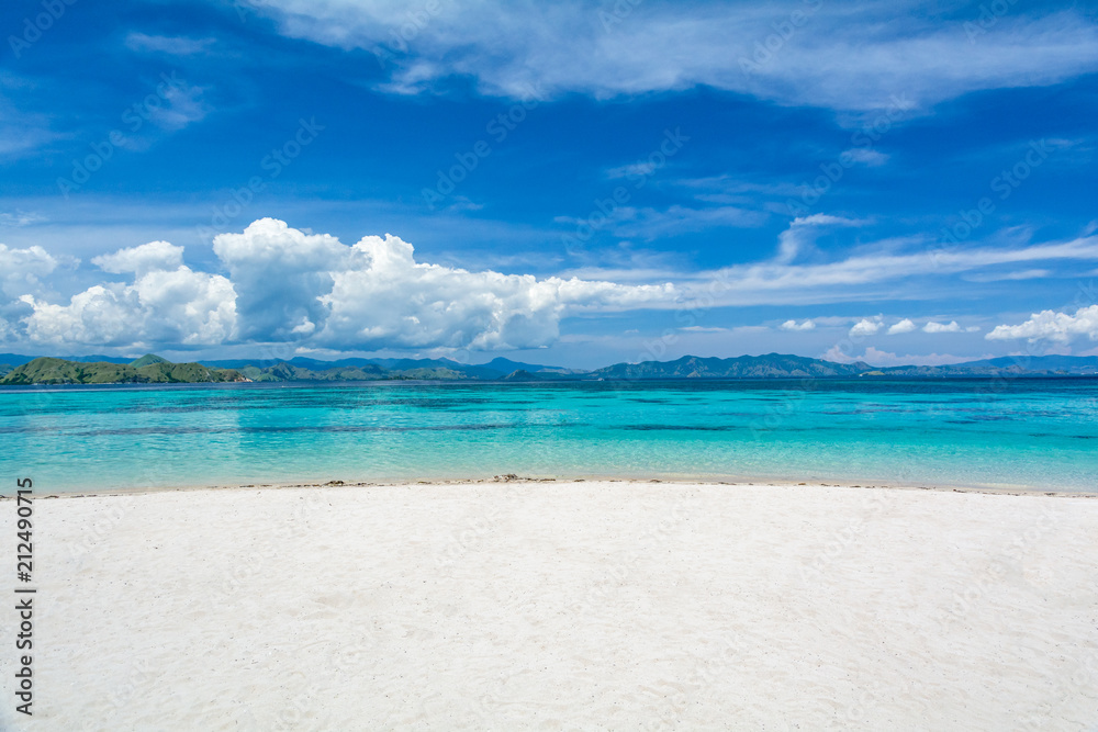 White Sand Beach with Two Different Color of Clear Turquoise and Blue Sea at Kanawa Island, Komodo National Park, Labuan Bajo, Indonesia White Sand Beach with Two Different Color of Clear Turquoise and Blue Sea at Kanawa Island, Komodo National Park, Labuan Bajo, Indonesia