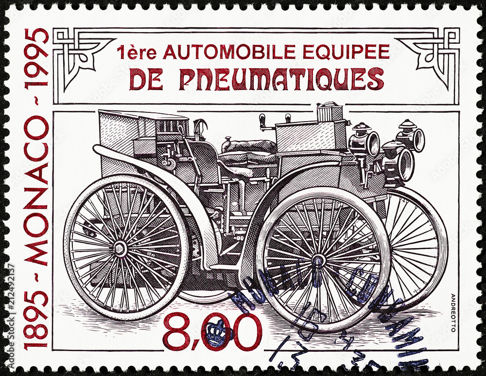 First car equipped with tires on postage stamp