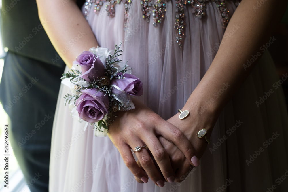 Close up of prom or weeding couple, focusing on an elegant girl's hands,  with a diamond