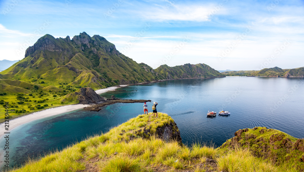 Happy Hikers Standing on Cliff Mountain, Enjoy the View Of Padar Island Before Sunset. Komodo National Park, Indonesia
