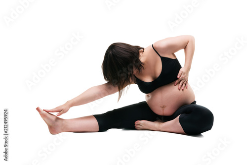 Pregnant woman in yoga pose isolated on white background