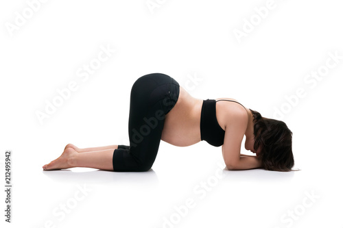 Pregnant woman in yoga pose isolated on white background