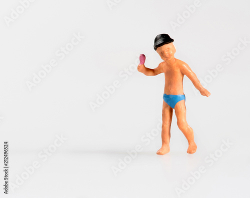 Little miniature toy boy holding an ice cream