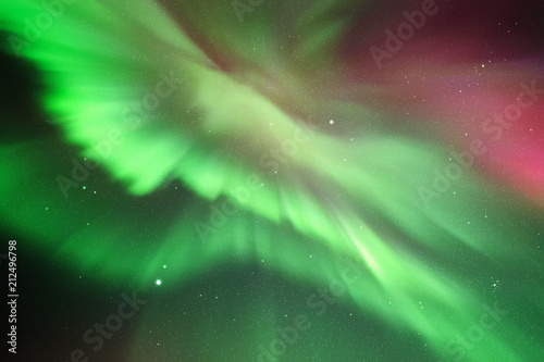 Night starry sky and Northern lights. Green aurora borealis