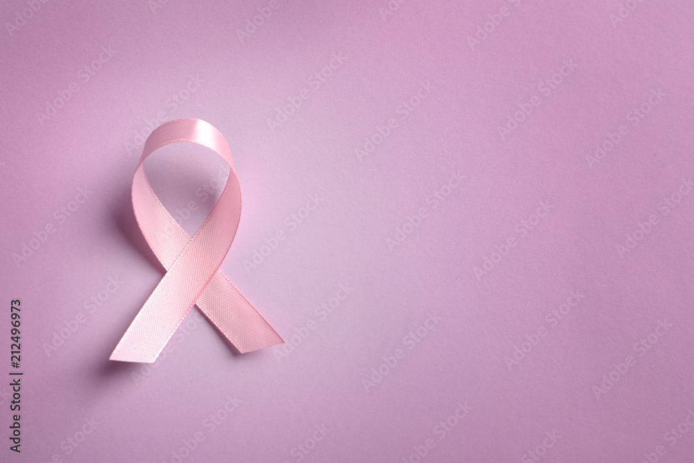 Pink ribbon on color background, top view. Cancer awareness Pink ribbon on color background, top view. Cancer awareness