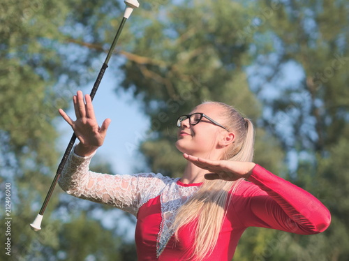 Teen Majorette Girl Twirling Baton Outdoors
