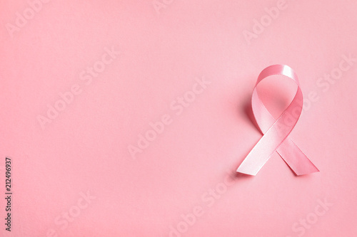 Fotografia Pink ribbon on color background, top view. Cancer awareness