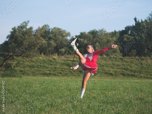 Teen Majorette Girl Twirling Baton Outdoors