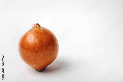 Fresh ripe onion bulb on light background