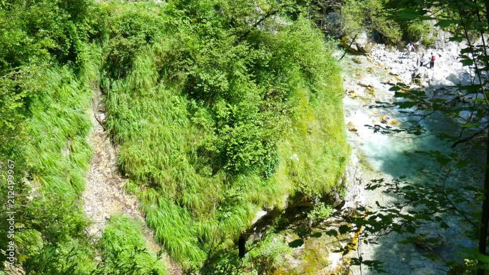 View on the distinct emerald green Soca River as it flows through the rocky riverbed in Slovenia.
