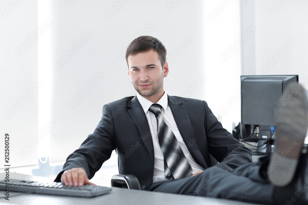 confident businessman sitting at Desk in a private office confident businessman sitting at Desk in a private office