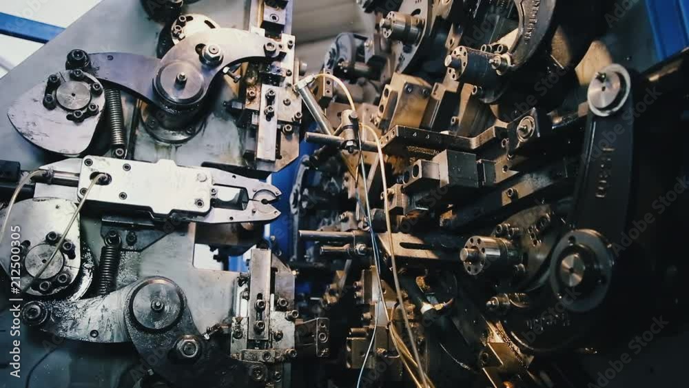 Automatic industrial conveyor machine for the manufacture of parts from steel wire. A lot of gears in one big gear.