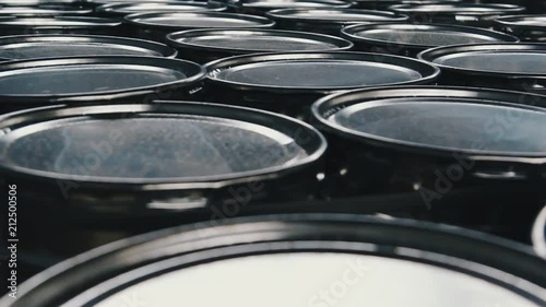Metal barrels.  Oil barrels or chemical drums stacked up. Steel barrels in a wholesale warehouse ready for shipment.