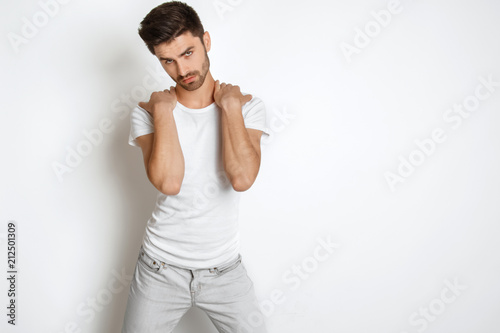 Strong face male model in casual style in white t sirt and jeans on white background