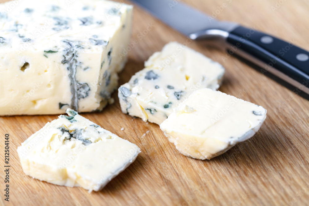 blue cheese on a wooden background with knife