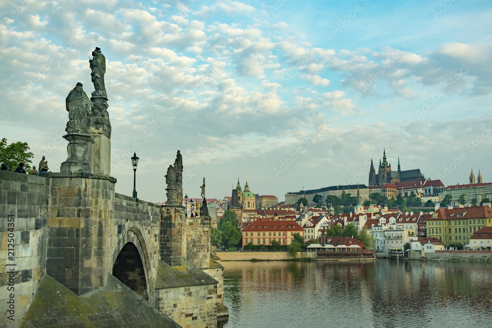 Charles Bridge in Prague with sculptures, against the background of a cloudy morning sky