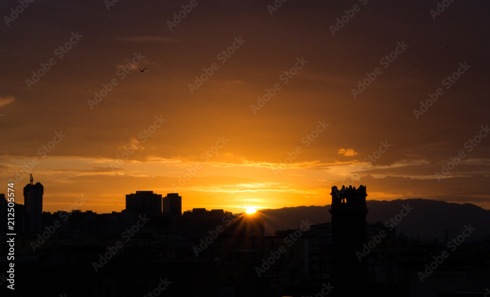 Sunrise over Naples, Italy. Rising sun with buildings silhouettes. Morning and sunrise concept. Early morning in city. Morning landscape. 