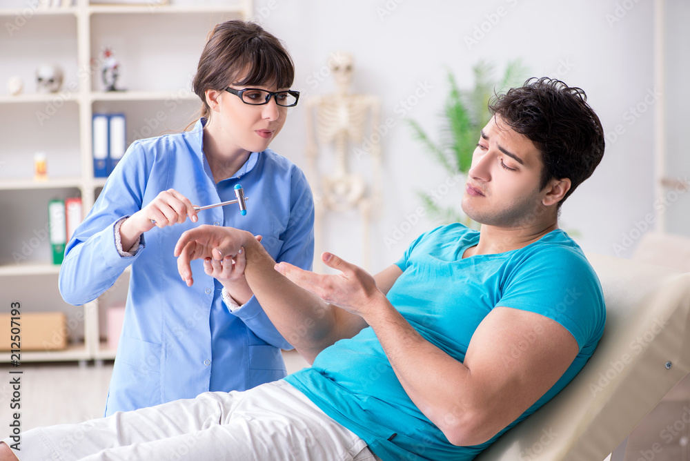Doctor checking nerve reflexes with hammer Doctor checking nerve reflexes with hammer