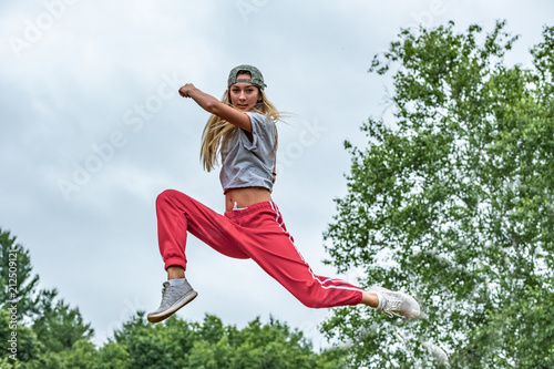 An athletic girl jumping in air.