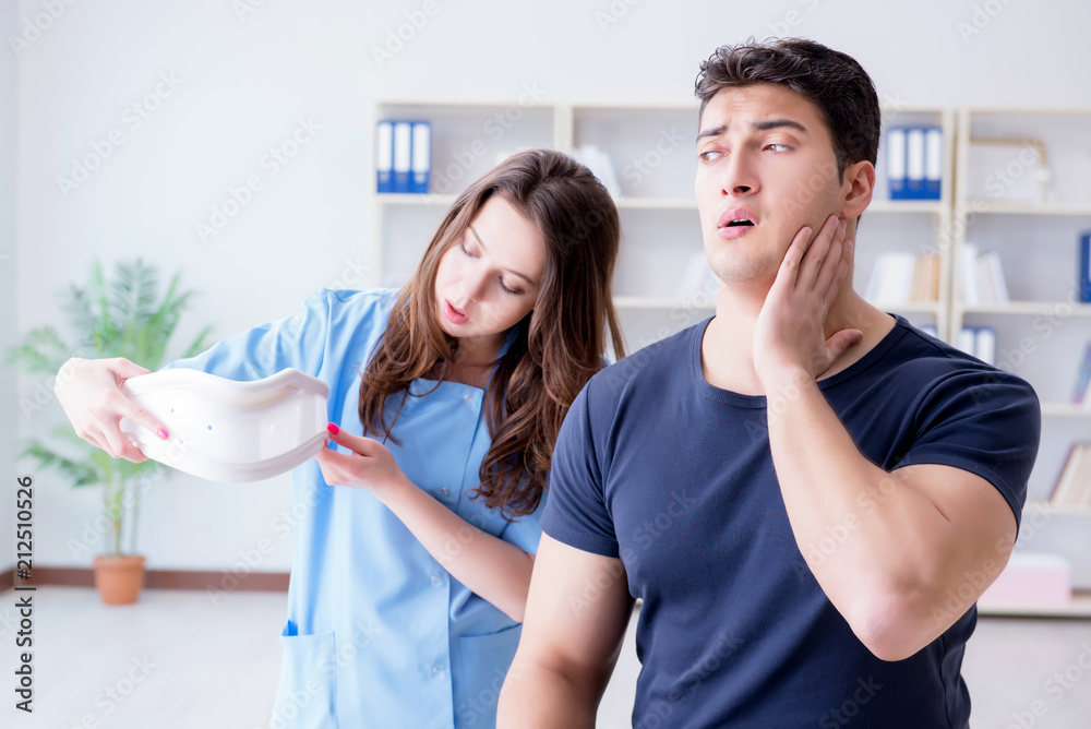 Fototapeta premium Man with neck injury visiting doctor for check-up