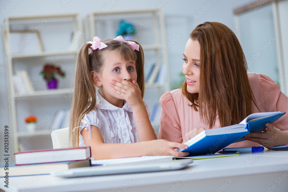 Mother helping her daughter to do homework Mother helping her daughter to do homework