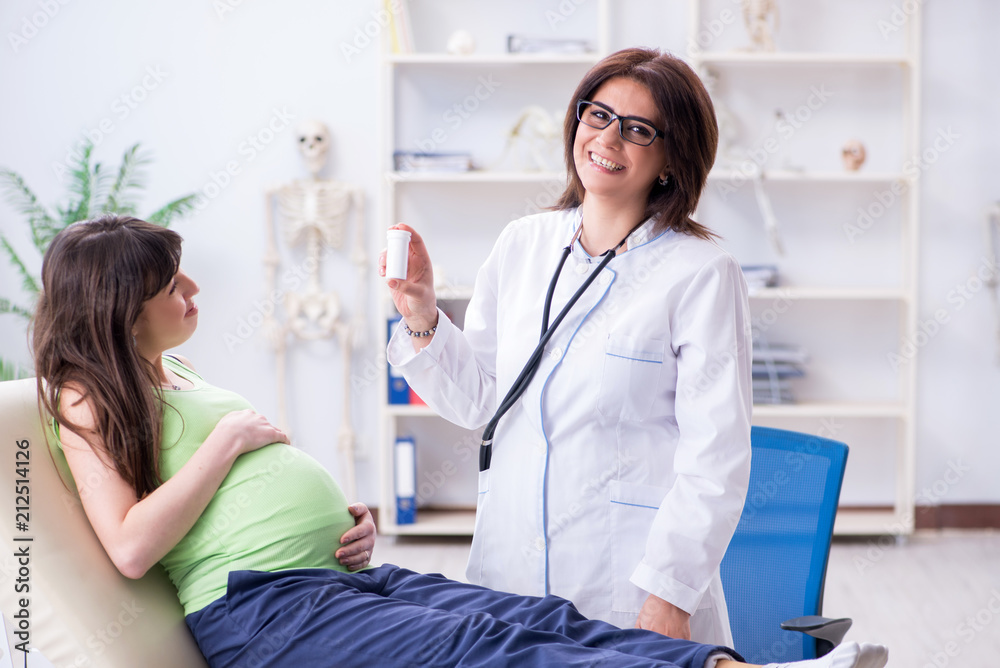 Pregnant woman visiting doctor for regular check-up Pregnant woman visiting doctor for regular check-up