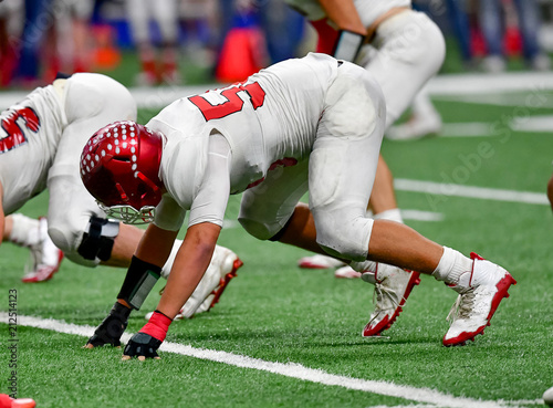 Photography Football lineman blocking and rushing during a football game