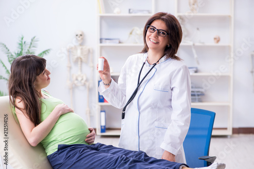 Pregnant woman visiting doctor for regular check-up