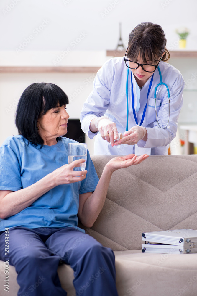 Young doctor visiting old mature woman for check-up Young doctor visiting old mature woman for check-up