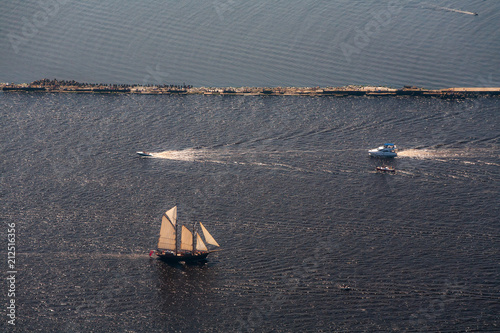 Several yachts and sailboats go to sea under sail. View from above. photo