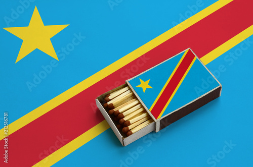 Democratic Republic of the Congo flag  is shown in an open matchbox, which is filled with matches and lies on a large flag photo