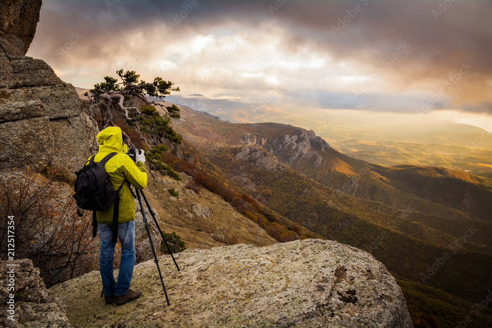 The photographer shoots the sunrise. Demerdzhi, Crimea The photographer shoots the sunrise. Demerdzhi, Crimea