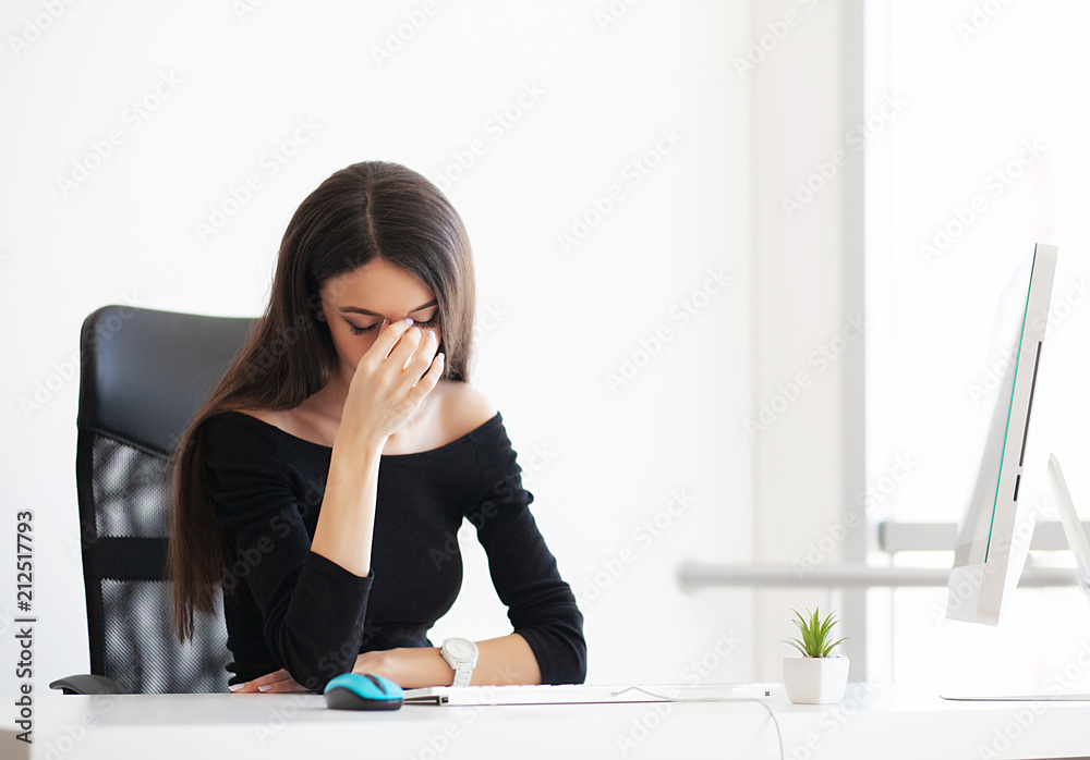 Pain. Depressed Business Woman. Beautiful Young Girl Sits in The Office at The Table and Holds Her Hands Near Her Head. Pain. Depressed Business Woman. Beautiful Young Girl Sits in The Office at The Table and Holds Her Hands Near Her Head.