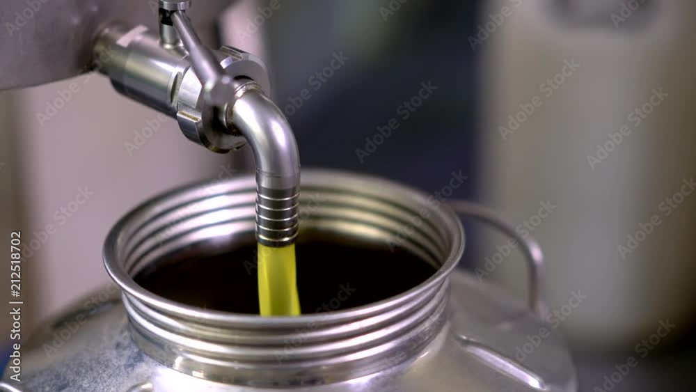 Olive oil fill into a stainless tank. Olive oil fill into a stainless tank.