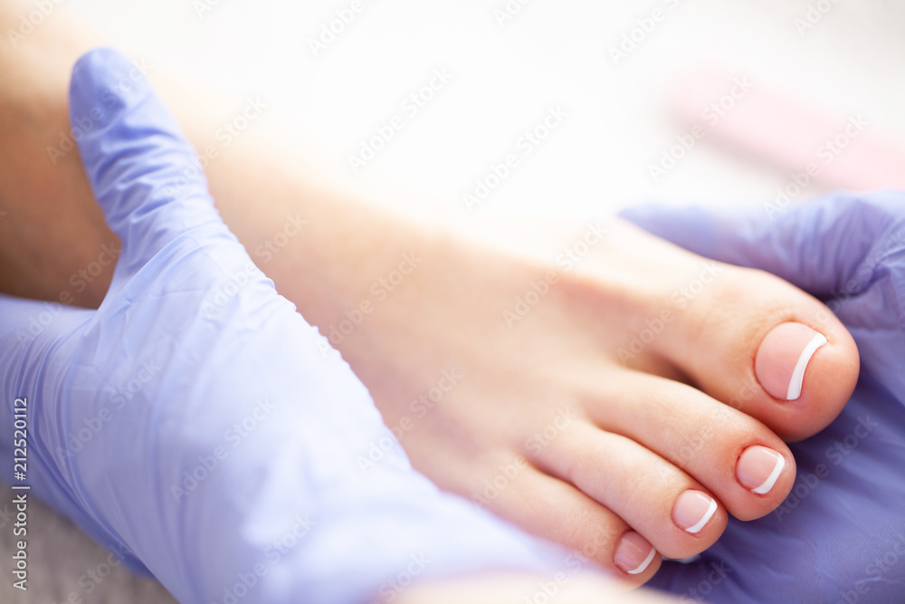 Fototapeta premium Pedicure Day. Pedicure Specialist Works With the Patient in Spa Salon