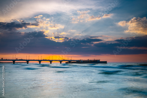Sunset on the beach with breakwater, long time exposure © dziewul