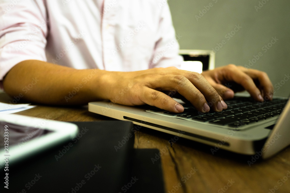 Close up hands man using laptop on the table. Close up hands man using laptop on the table.