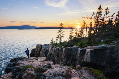Hiker watching the setting sun at Acadia National Park