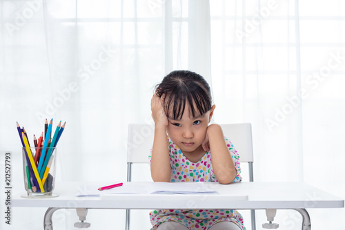 Asian Little Chinese girl doing homework