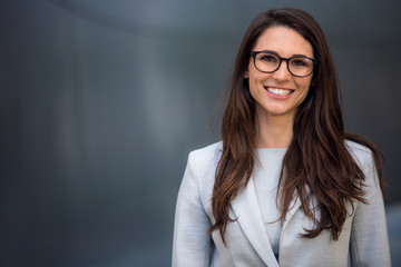 Smart, intelligent, friendly, likable portrait of an executive business woman manager, advisor, agent, representative with glasses