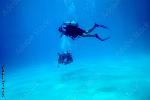 Scuba Divers over sandy bottom