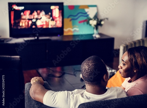 Black spouse watching movie enjoy precious time together