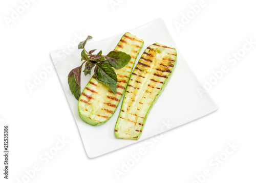Grilled sliced vegetable marrows on the square white dish