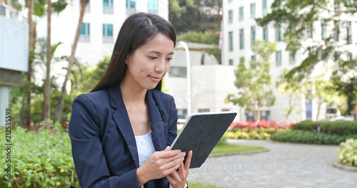 Photography Asian Businesswoman use of tablet computer at outdoor